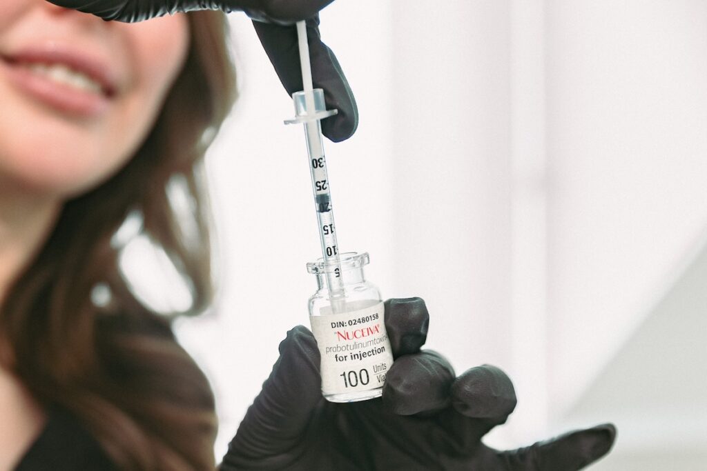 A provider at Cosmedica Aesthetics uses a syringe and a vial of Nucevia to provide wrinkle prevention in Burlington.